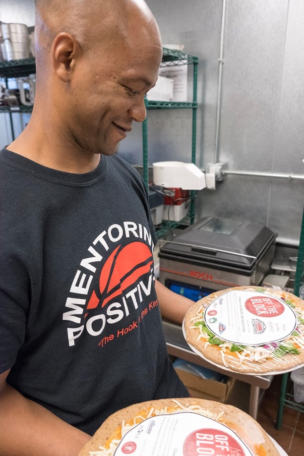  Will Green of Mentoring Positives holding Off the Block Pizzas